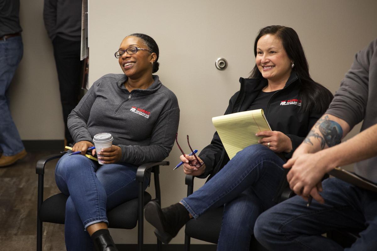 Staff members smiling during a meeting